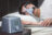 Asian,Man,With,Sleep,Apnea,Using,Cpap,Machine,,Wearing,Headgear